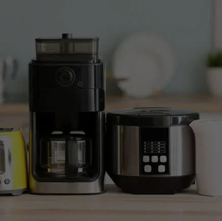 Modern kitchen appliances including coffee maker, rice cooker, and toaster on countertop