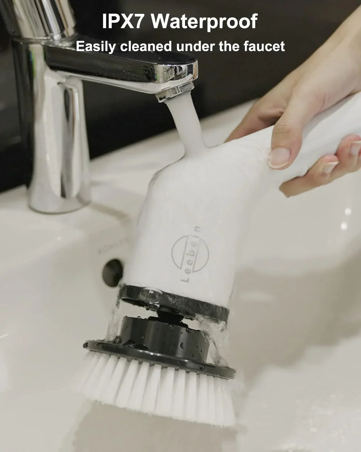 IPX7 waterproof cleaning brush being rinsed under faucet for easy maintenance